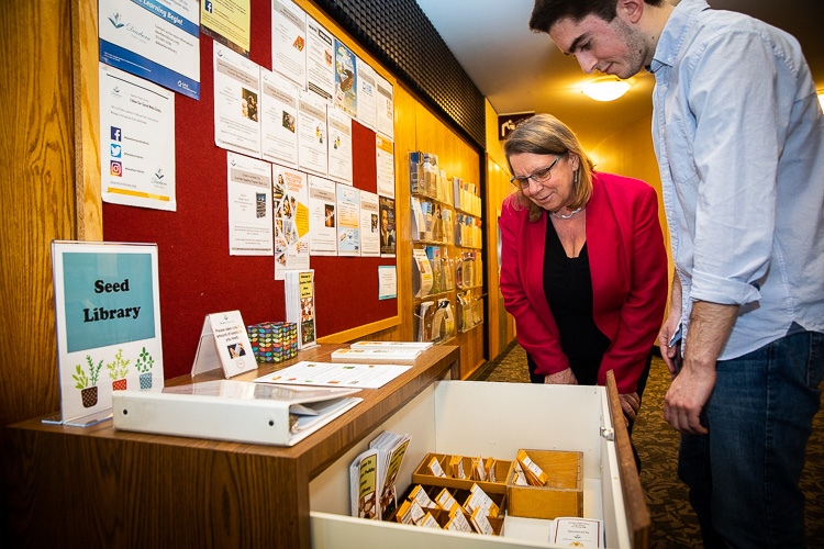 Kate Pepin helps a patron with the seed library.