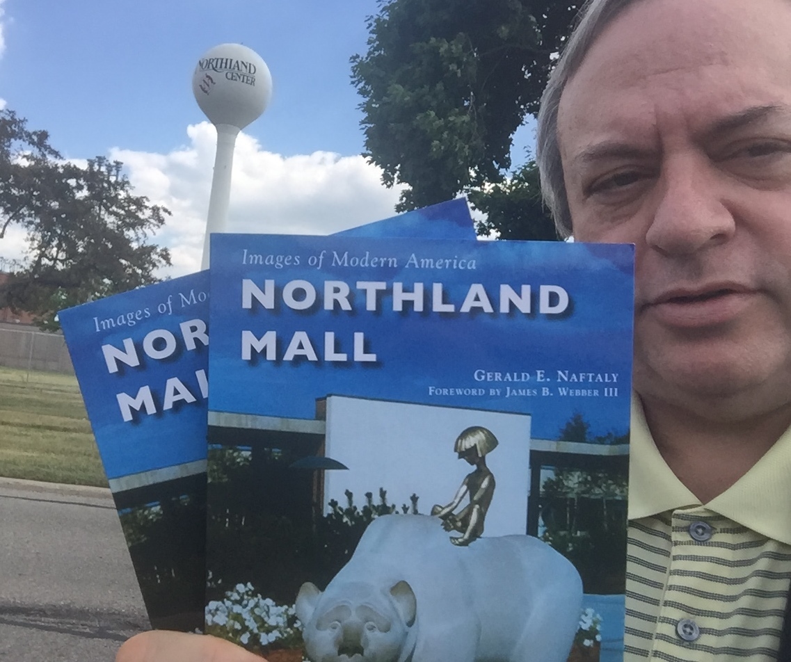 Author Jerry Naftaly with his book near the Northland Center water tower. Photo courtesy .