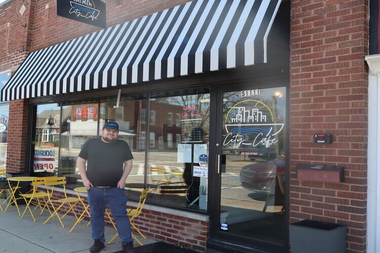 City Café Owner Kyle Dudek poses for a photo outside his New Baltimore restaurant.