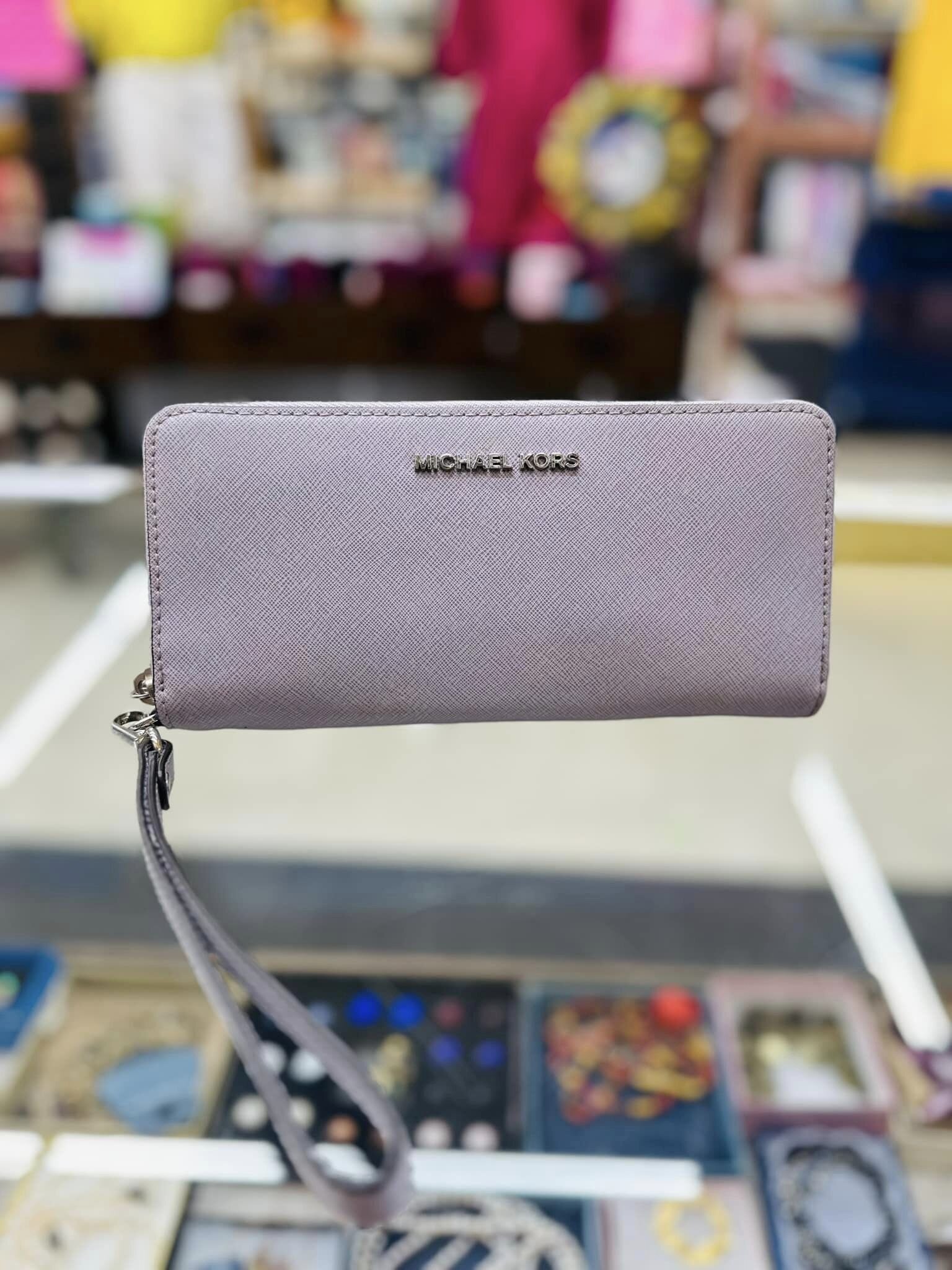 A Michael Kors wristlet wallet inside Second Glance.
