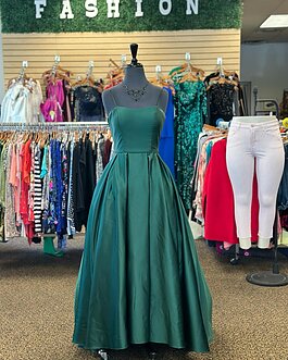 A green gown showcased on a mannequin at Trove Boutique Resale.