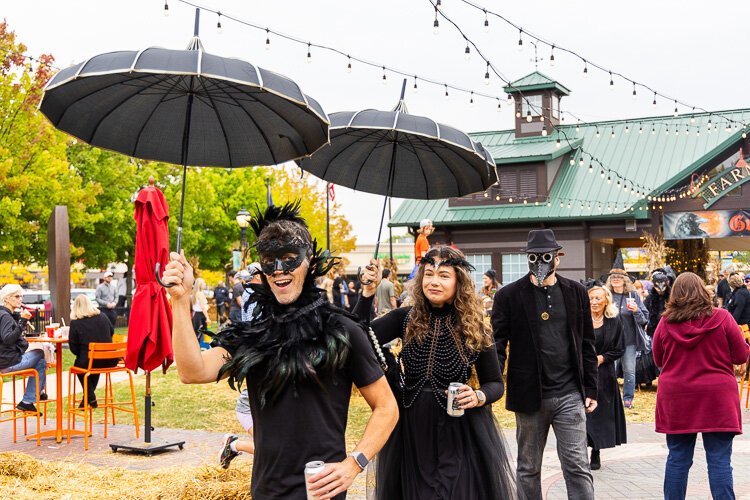 Festival-goers join in the fun and parade with the band through downtown Farmington.