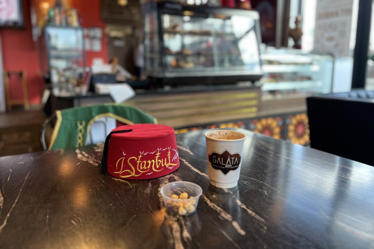 Imad Mohamad has spared no expense in outfitting his cafe with authentic touches of home, including traditional vests and fez hats, or tarboosh, that adorn the tables and made available to wear.