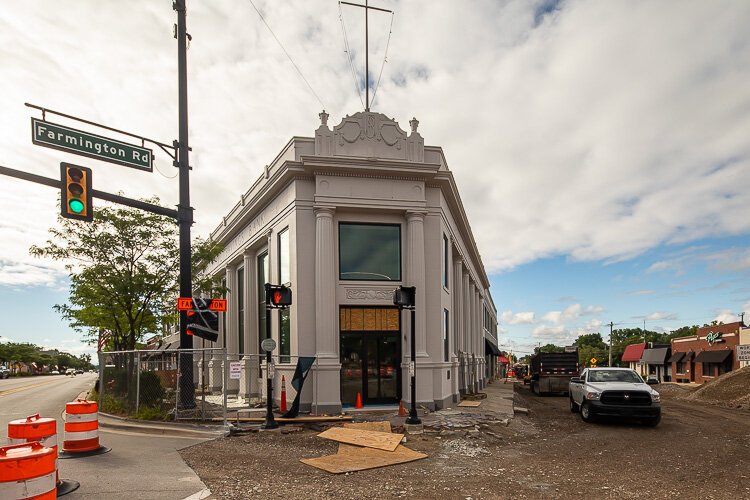 Outside the new headquarters, construction crews are working on the Farmington Road Streetscape Project