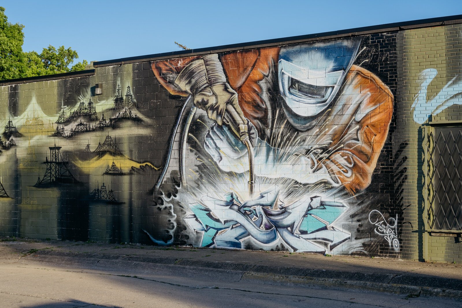 The welder mural, by Sintex, on the side of the studio of Brian DuBois, is a well-known backdrop to the city's scene.