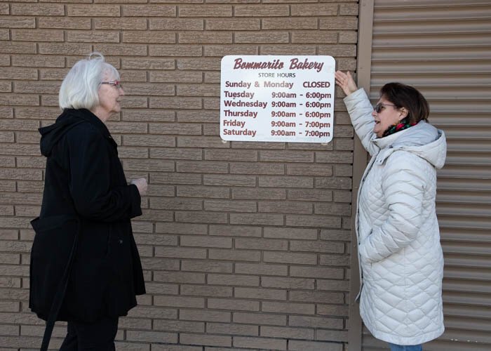 Customer and supporter, Virginia Stolarski shares her love of the neighborhood bakery with other customers.  Photo: Chris Estrada.