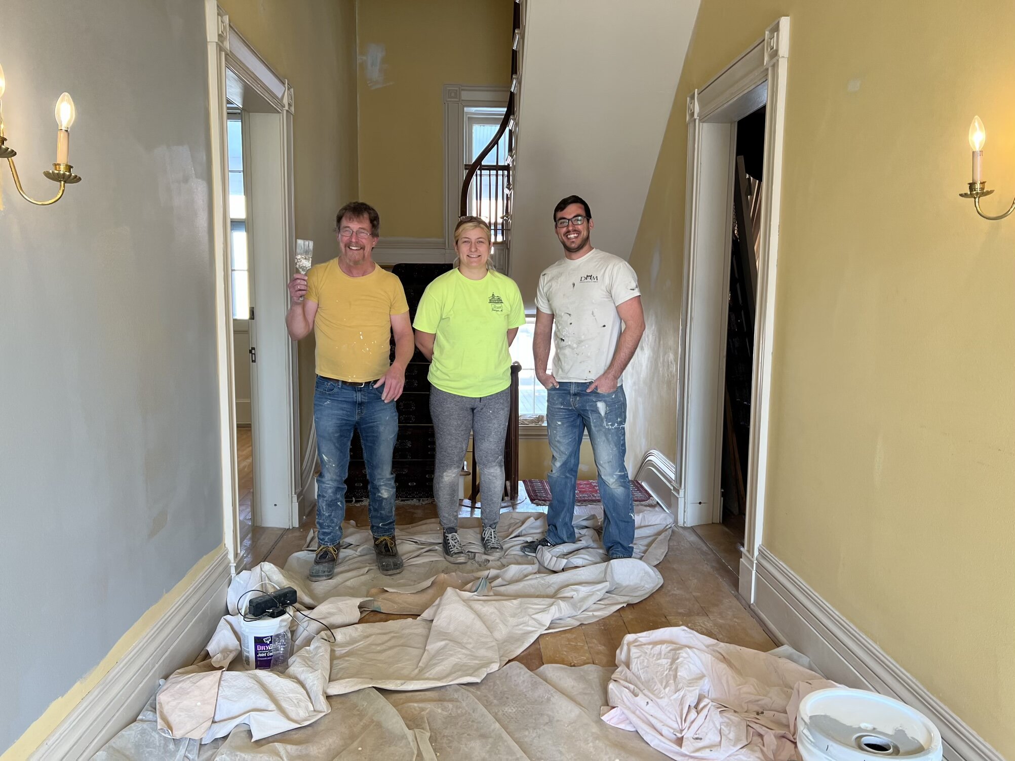 Tyler Moll, exhibits designer for the Dearborn Historical Museum, is joined in the renovations by James (right), a volunteer, and Audrey Wicklander (center), a museum intern.