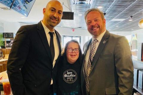 Rebecca Smither, pictured here with Lava Mountain Coffee owners Ziad Kassab and Chris Barnett, enjoys her job as a barista at the Lake Orion coffee shop.