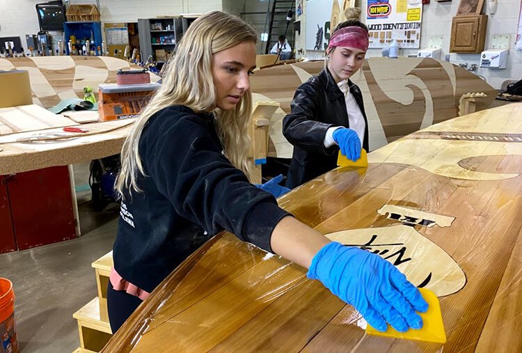 Rosalina Cholewa and Sydney Szymanski put the finishing touches on a board.