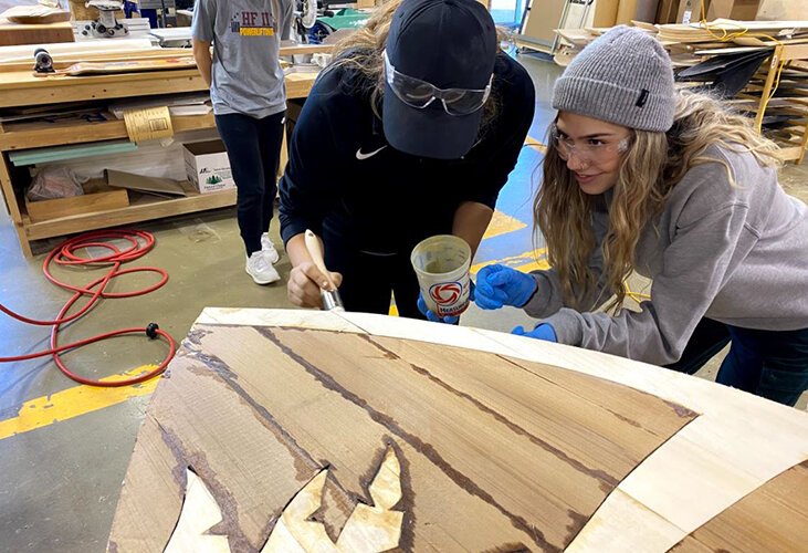 Toni Nunnery and Sidney Dobroczynski work on one of their designs. 