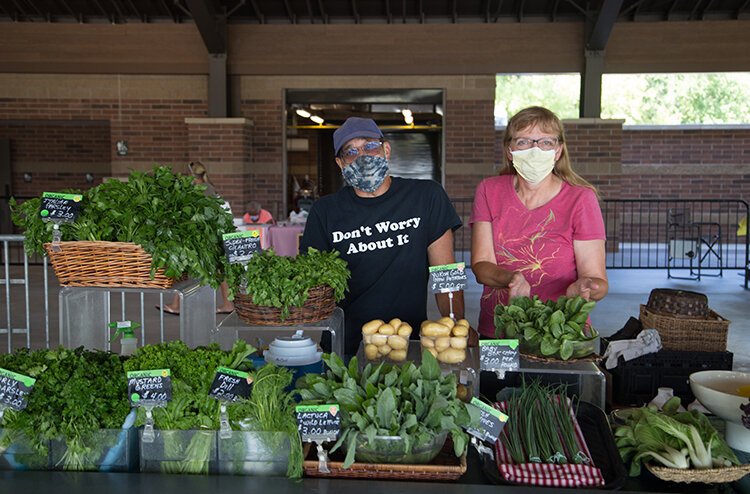 Michael McCoul and Jo-Anne Charboneau, of Black Earth Farms, selling their produce at the Doge Park Farmers Market.