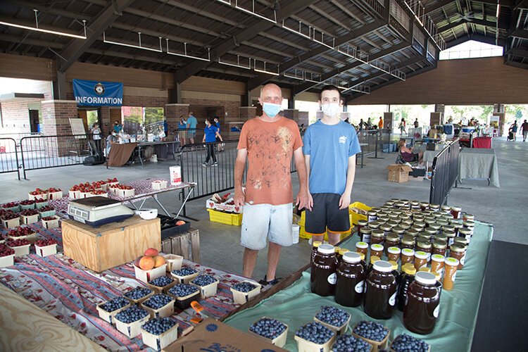 Ray and Aiden Smith donning masks for the reopening of the market in Sterling Heights.