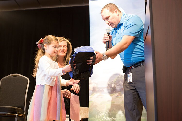 Abigail Coldicott receives a "swag bag" from Kyle Langlois.