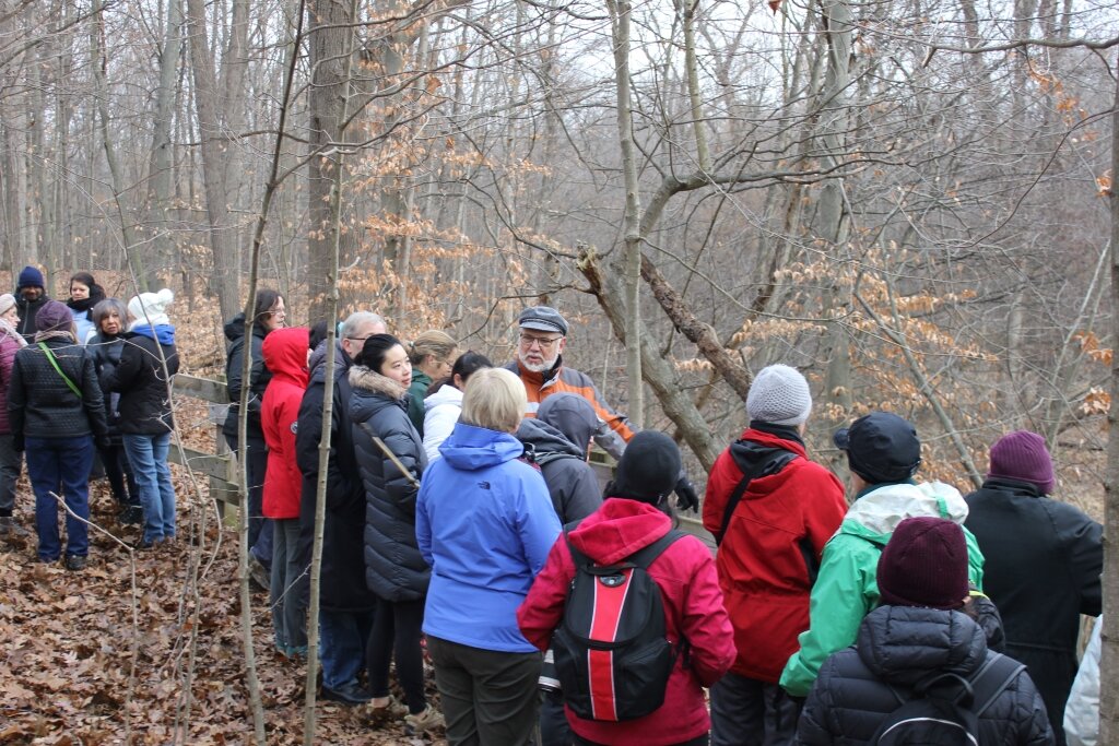 Phil Crookshank explains erosion on the Rouge River to hikers. Photo by Jeff Burtka.