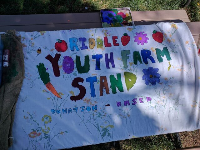 A sign for the Riddle Youth Farm Stand.