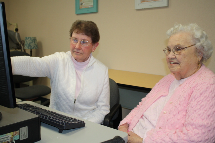 Betty (in pink) connects with her sister in the âold countryâ using CommunO2 with the help of Mary, a retired senior volunteer in Otsego County. Betty had not seen her sister in about 15 years.