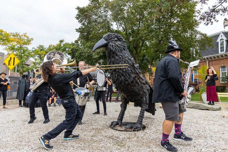 Brass Animals and the crowd rally around Edgar the Grand Raven in front of downtown's historic Masonic Hall in 2023. (File photo: David Lewinski)