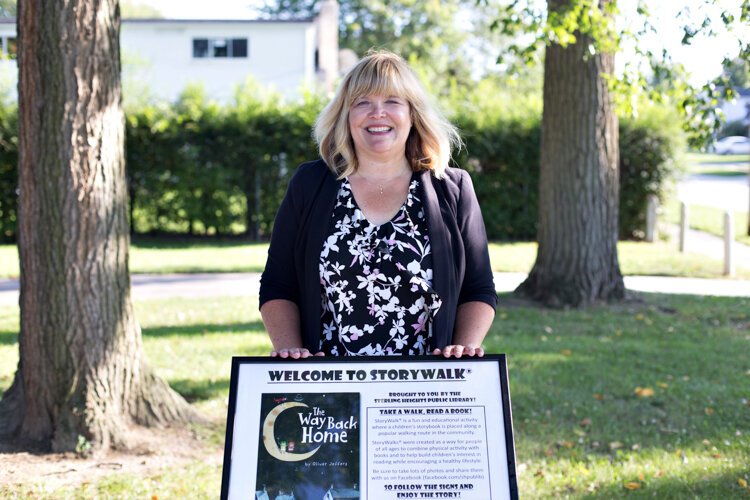 Library Director Tammy Turgeon proudly shows off one of the story boards.