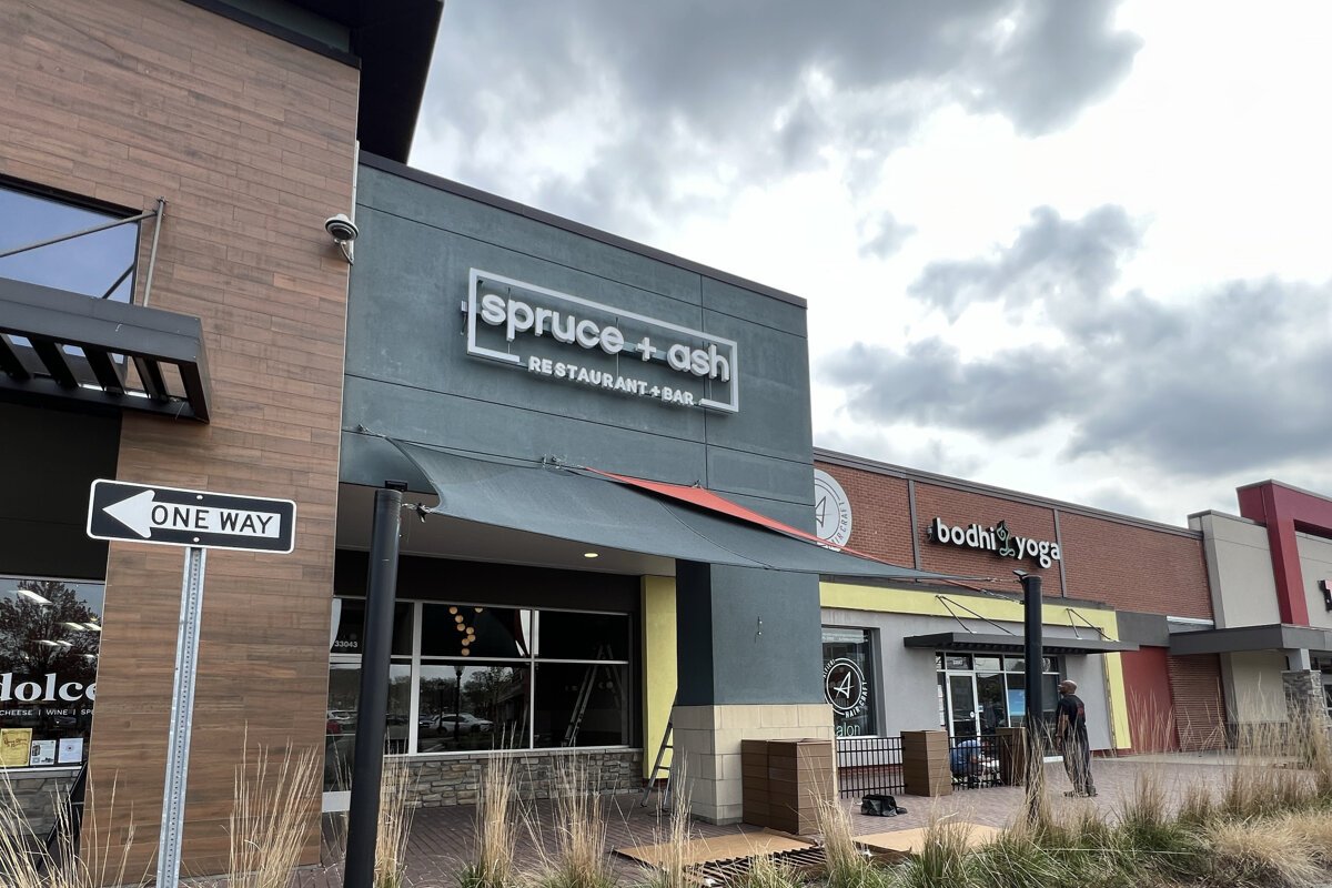 Putting the sign up at Spruce & Ash in downtown Farmington.