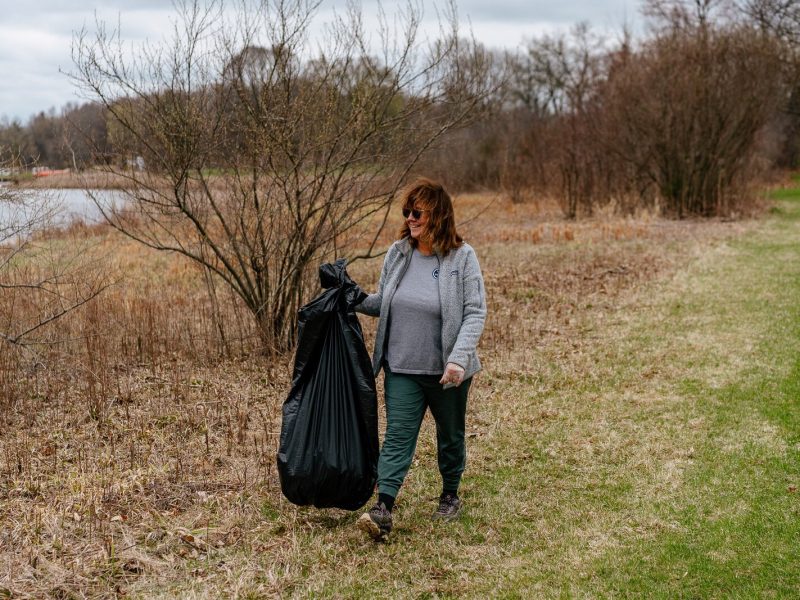 Roz Nowosielski picks up trash at Stony Creek Metropark during an Earth Day cleanup event. She walks at the park every day and wanted to help clean it up.