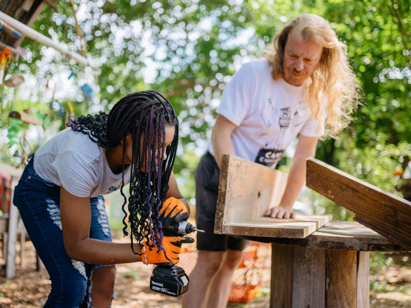 A Camp Carpenter participant works on a project with a counselor at Carpenter Park in Detroit.