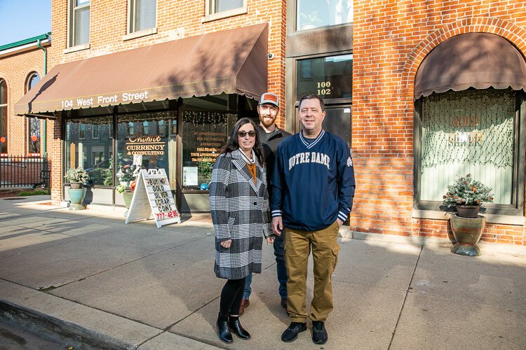 Ann and Joe Peruski stand with their son in front of a building in downtown Monroe they refurbished which is where they now live and work.
(Photo by David Lewinsky)
