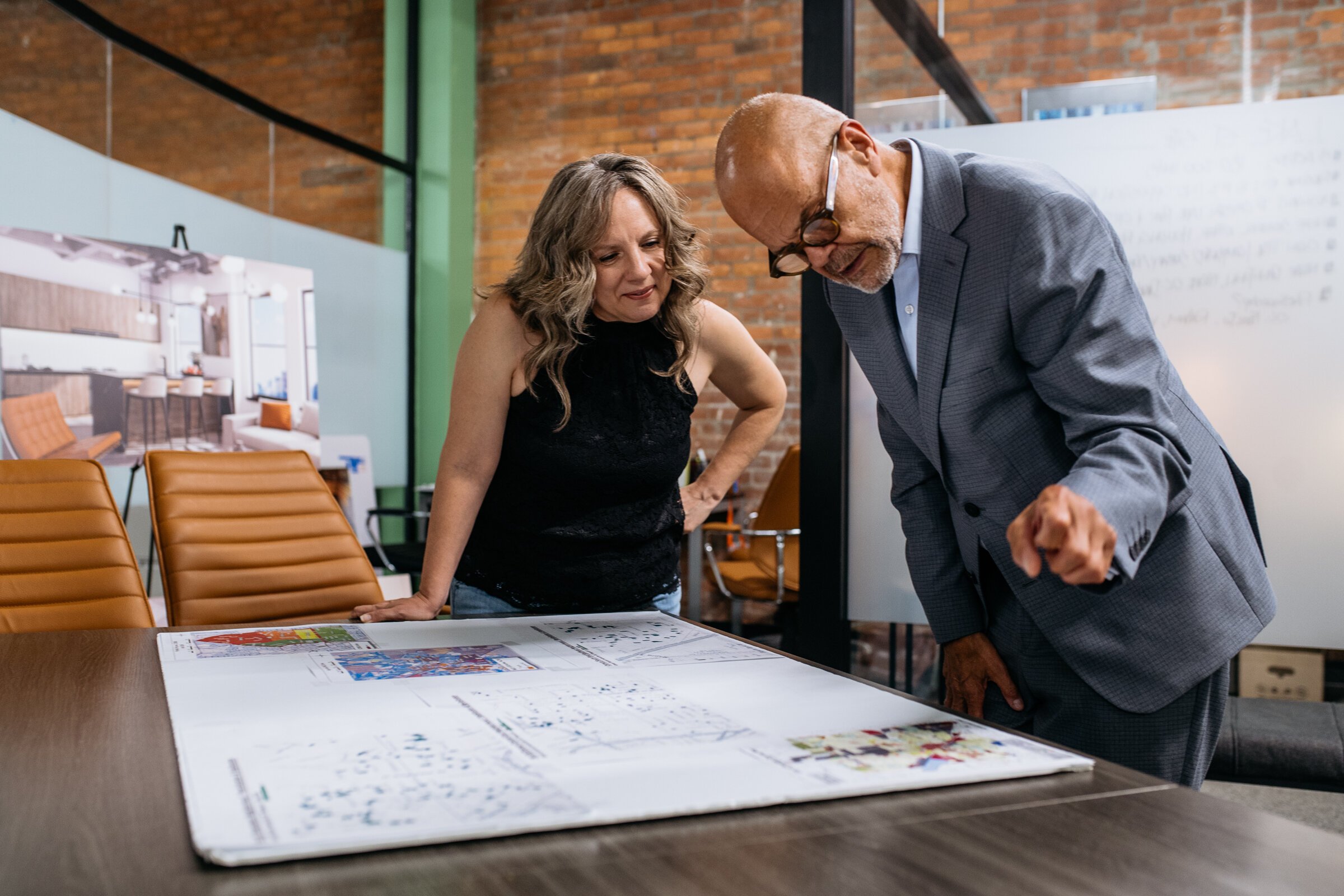 Leah DuMouchel, director of programs and communications at the Michigan Association of Planners, and Vern Gustafsson, project director/planner at the Pontiac Housing Development Corporation, look over zoning maps.